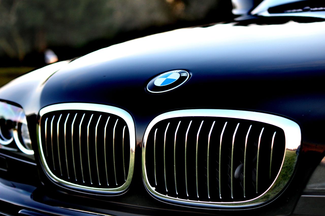 Crafting Captivating Headlines: Your awesome post title goes here Detailed view of a luxury car's front grill and logo in focus.