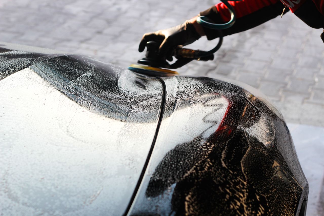 The Art of Drawing Readers In: Your attractive post title goes here Close-up of a car being polished by hand, showcasing professional detailing and maintenance.